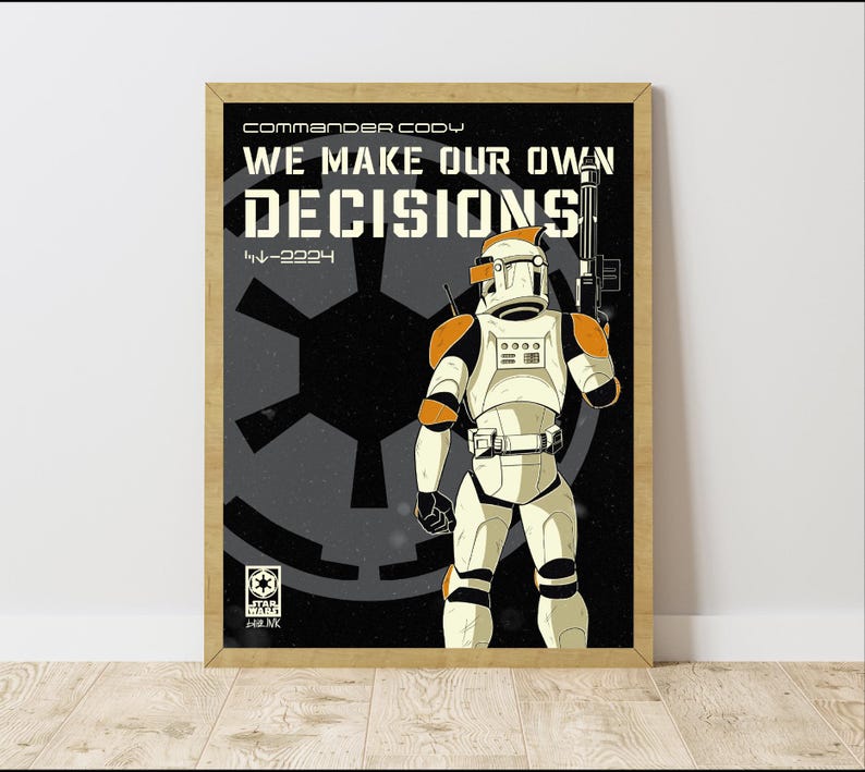 May include: Framed poster with a Star Wars theme, showing a clone trooper in white and orange armour, holding a blaster. The poster has the text "WE MAKE OUR OWN DECISIONS" and "Commander Cody" in white against a black background.