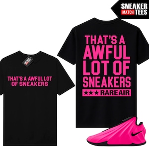 May include: A black short-sleeve t-shirt featuring the pink text THAT'S A AWFUL LOT OF SNEAKERS on the front and back. The back also includes the text RAREAIR with three stars. A bright pink sneaker with a black sole is positioned at the bottom right.