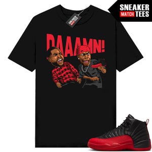 May include: Black t-shirt with a cartoon graphic of two men and the word "DAAAMN!" in red. The shirt is paired with a black and red Air Jordan 12 sneaker. The tag reads "SNEAKER MATCH TEES".