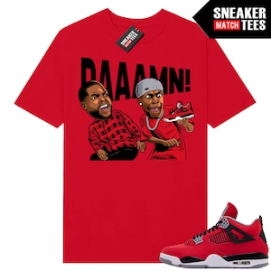 May include: Red t-shirt with a cartoon graphic of two men and the word "DAAAMN!". The shirt is paired with a red, black, and white sneaker. A "Sneaker Match Tees" tag is visible.