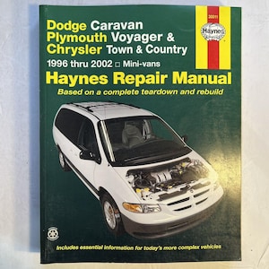 May include: Haynes Repair Manual for Dodge Caravan, Plymouth Voyager & Chrysler Town & Country mini-vans from 1996-2002. The cover features a white minivan with the hood open, showcasing the engine. The manual includes essential information for complex vehicles.