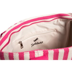 May include: Inside of a pink and white striped tote bag with a zippered pocket and the text "Taskita49" with a dragonfly logo.