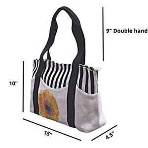 May include: A black and white striped tote bag with a sunflower print and a 9" double handle. The bag measures 10" tall, 15" wide, and 4.5" deep.