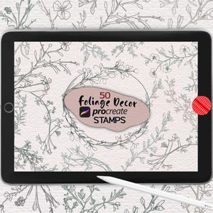 May include: A black tablet displays a digital art design with a floral theme. The screen shows a light pink shape with the text "50 foliage Decor procreate STAMPS". A white stylus rests near the tablet. The background features a repeating floral pattern.