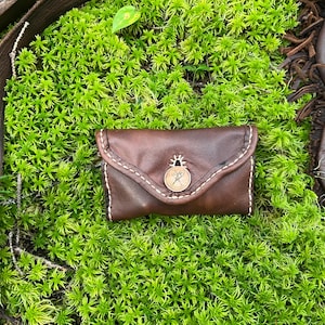 Fancy flint wallet and tool pouch, fully lined veg tan leather, hammered copper button and handstitched with linen.