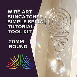 May include: A silver wire art suncatcher with a spiral design and a clear, faceted crystal ball. The text on the left reads "WIRE ART SUN CATCHER SIMPLE SPIRAL TUTORIAL TOOL KIT" and "20MM ROUND". A rainbow graphic is at the bottom.