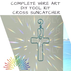 May include: A teal wire art cross suncatcher with a clear crystal pendant. The cross is suspended against a white background with light refractions. The text "COMPLETE WIRE ART DIY TOOL KIT CROSS SUN CATCHER" is at the top.