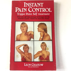 May include: A red book titled "INSTANT PAIN CONTROL" with the subtitle "Trigger Point Self-treatment." The cover shows four images of a person demonstrating self-help pressure techniques. The author's name, Leon Chaitow, is printed at the bottom.