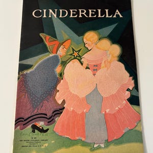 May include: Vintage "Cinderella" book cover illustration. The cover features a colourful illustration of Cinderella and the fairy godmother. The title "CINDERELLA" is at the top. The cover is from The Harter Publishing Company.