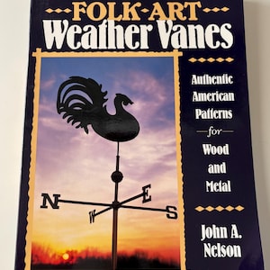 May include: A book titled "FOLK-ART Weather Vanes" features a black rooster weather vane illustration against a sunset backdrop. The cover includes text: "Authentic American Patterns for Wood and Metal" by John A. Nelson.