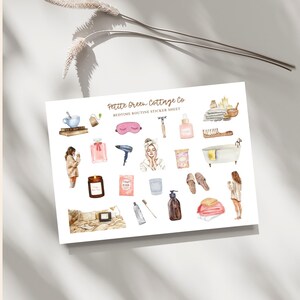 May include: A white sticker sheet with watercolor illustrations of bedtime routine items. The sheet includes images of a teacup, perfume, a hairdryer, a candle, a bath, and a person in a robe. The text "Petite Green Cottage Co" is visible.