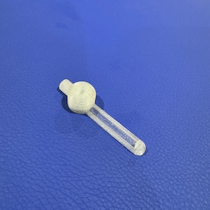 May include: A clear plastic pipe with a white plastic ring on the end.