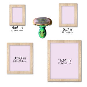 May include: Four different sizes of wooden picture frames with white mounts. The frames are 4x6 inches, 5x7 inches, 8x10 inches, and 11x14 inches. A small green and purple mushroom figurine is in the centre of the image.