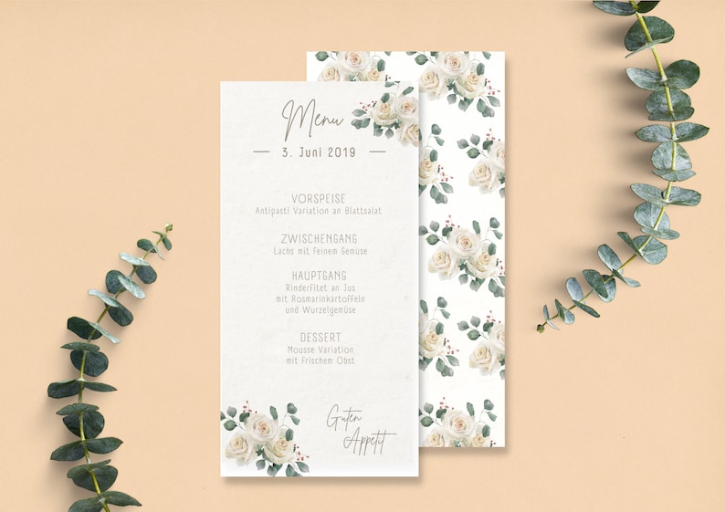May include: A white menu card with a floral design featuring white roses and green leaves. The menu card lists the courses for a wedding reception: Antipasti Variation, Lachs mit feisen Senize, Rinderfitet an lut, Mousse Variation, and Guten Appett. The date is 3. Juni 2019.