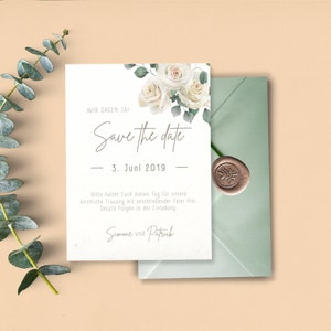 May include: Save the date card with white roses and greenery. The text reads "Wir sagen Ja! Save the date - 3. Juni 2019 - Bitte haltet euch diesen Tag f&uuml;r unsere kirchliche Trauung mit anschlie&szlig;ender Feier frei. Details folgen in der Einladung. Simone und Patrick"