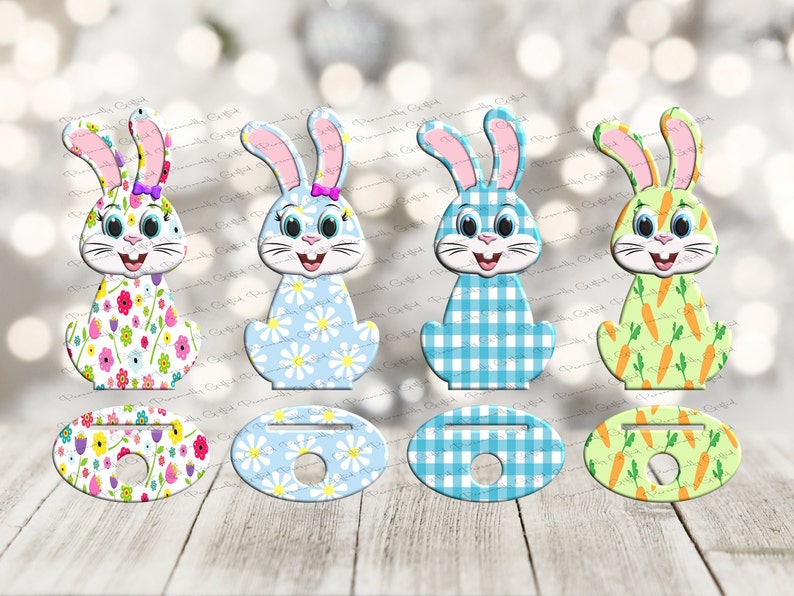 May include: Four Easter bunny themed cupcake toppers. Each topper features a different pattern: floral, daisy, plaid, and carrots. The toppers are made of wood and have a hole in the center for inserting a cupcake stick.