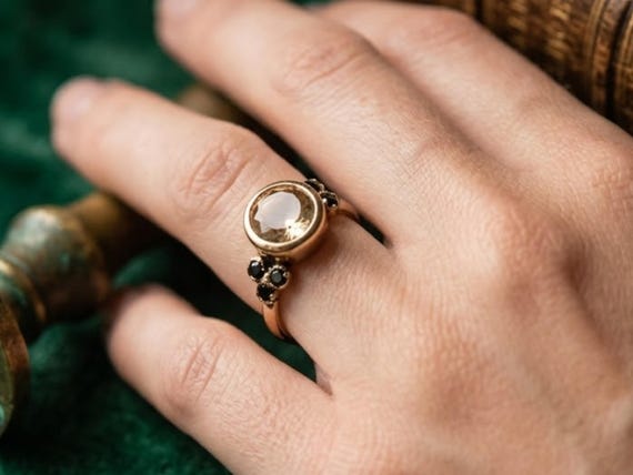 A 9K gold ring pairing citrine and tourmaline in an ethnic-inspired setting — a birthstone piece with genuine artisan character and 13 favorites backing it.