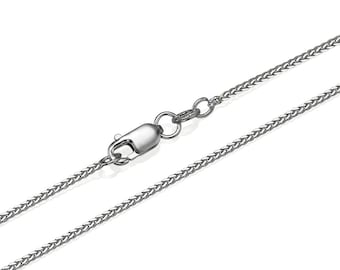 May include: A silver chain necklace with a lobster clasp closure. The chain is a delicate, fine-link style.