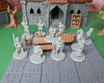 May include: A collection of miniature figurines, including characters and furniture, arranged on a gray tiled surface. The scene includes a building, a tree, and a wooden table, suggesting a fantasy or tabletop game setting.