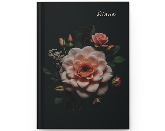 May include: Black journal with a floral design. A large, light pink flower is the focal point, surrounded by smaller pink roses and buds. The name "Diane" is written in gold script at the top.