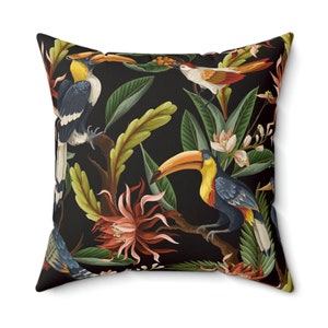 May include: A black throw pillow with a tropical print featuring toucans, birds, and flowers.