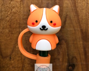May include: Orange and white cartoon dog pen topper with a tail that wraps around the pen. The pen is green and has the text "SparkleTastes Tumblers" on it.