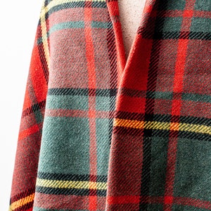 May include: Red, green and yellow plaid fabric with a woven texture.