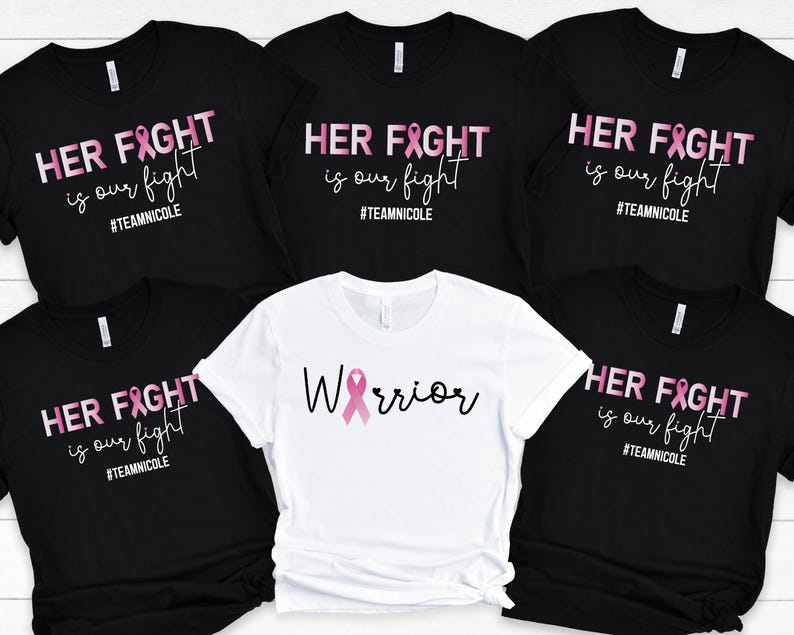May include: Five black t-shirts with pink ribbon graphics and the text "HER FIGHT is our fight #TEAMNICOLE" and one white t-shirt with a pink ribbon graphic and the text "Warrior".