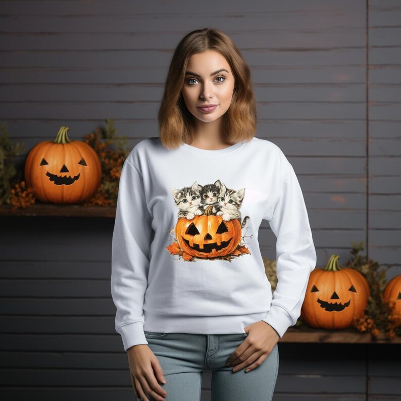 a woman standing in front of pumpkins with cats on them