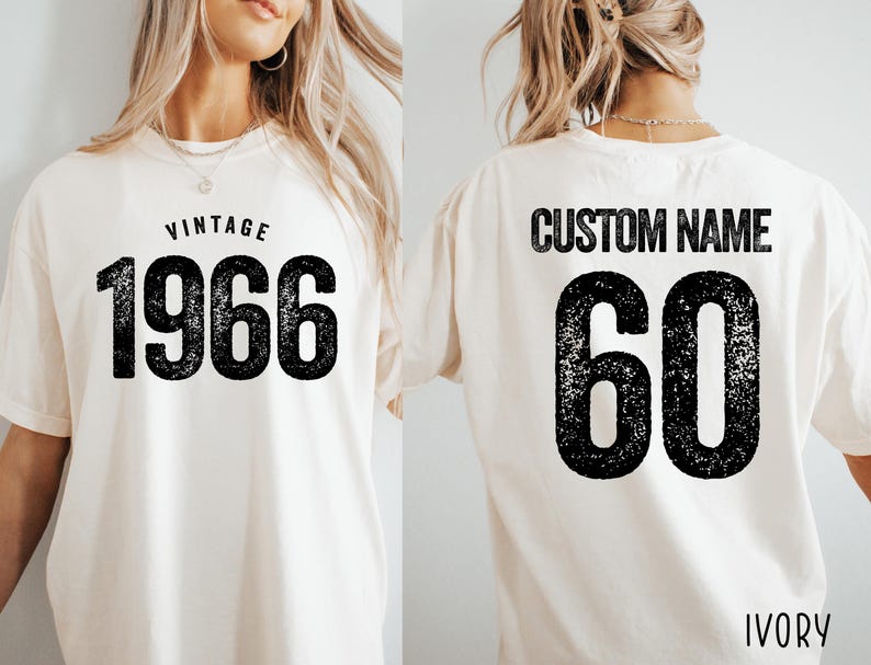 A white t-shirt with the text "VINTAGE 1966" printed on it, along with the number "60" below it. The t-shirt also has the text "CUSTOM NAME" printed on the back.