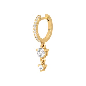 May include: Gold hoop earring with a dangling chain and two small round diamonds.