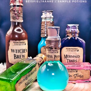 May include: Five glass bottles with labels and twine wrapped around the necks. The bottles contain different colored liquids and have labels that read "Witches Brew", "Antis Potion", "Mermaid Tears", and "Siren Tears".
