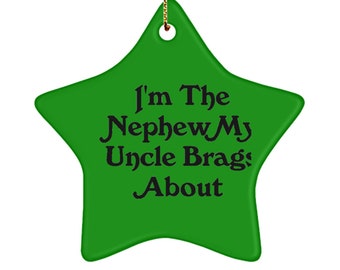 May include: A green star-shaped ornament with the text "I'm The Nephew My Uncle Brags About" in black. The ornament has a gold string for hanging.
