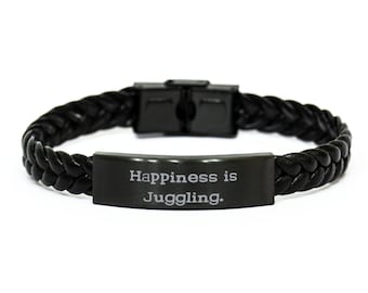 May include: Black leather bracelet with a black metal plate that says "Happiness is Juggling."