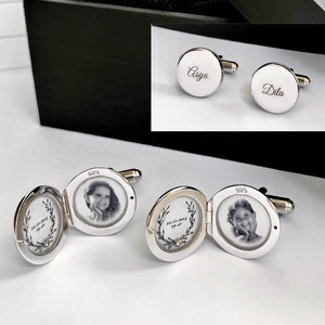 May include: Two silver cufflinks with a photo frame design. One cufflink has a photo of a young girl and the other has a wreath design with the text "24.12.2017" and "09.07.2019".