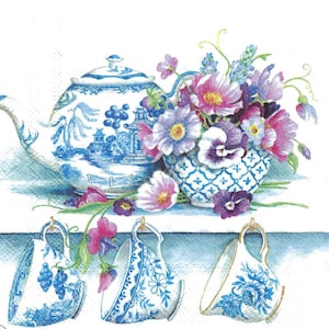 May include: A blue and white teapot with a floral design sits on a shelf with three matching teacups hanging from hooks. The teapot and teacups are decorated with a blue and white floral pattern. A bouquet of purple and pink flowers sits in a blue and white bowl in front of the teapot.