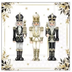 May include: Watercolor illustration of three decorative nutcrackers. The nutcrackers are in black, white, and gold, with detailed uniforms and facial features. One holds a tree, another a staff. The background is white with gold accents.