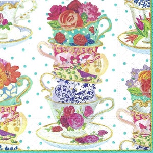 May include: A stack of five teacups and saucers decorated with floral patterns, butterflies, and birds. The cups are stacked on top of each other, with the top cup being the smallest. The cups are all different colors and patterns, and the saucers are all white with a gold rim.