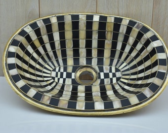 Brass sink created with unlacquered brass, bone and a resin finish