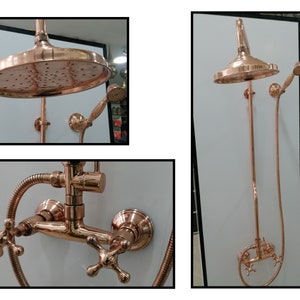 Red copper shower system including curved wall tube, wall mount faucet, cross knobs, round copper shower head and shower hose.