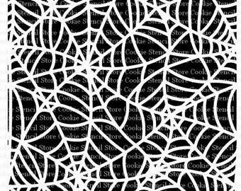 May include: A white spiderweb stencil on a black background. The stencil is designed for cookie decorating and features a detailed web pattern. The words "Cookie Stencil Store" are repeated around the edges.