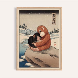 May include: A framed print featuring a cartoon orangutan and a chimpanzee embracing on a rock in a snowy landscape. The orangutan is brown, and the chimpanzee is black. The background includes a river, trees, and Japanese text.