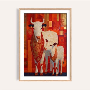 May include: Framed art print depicting a cow and calf. The white animals have decorative red and gold accents. The background is a patchwork of red, orange, and gold geometric shapes. The artwork is displayed in a light wood frame.