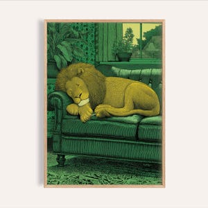 May include: A framed print showing a sleeping lion on a green sofa. The lion has a golden mane and is resting its head on its paw. The background features green wallpaper, plants, and a window with a garden view.