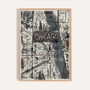 May include: A framed art print featuring a stylized map of Chicago in shades of gray, black, and red. The word "CHICAGO" is prominently displayed in graffiti-style lettering. The map includes landmarks, street names, and the outline of Lake Michigan.