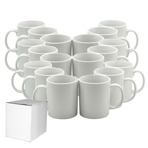 May include: A collection of white ceramic mugs with curved handles, arranged in a semi-circular pattern. A white cardboard box is in the lower left corner. The mugs are plain and cylindrical, suitable for beverages. The background is white.