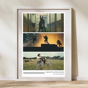 Op de afbeelding: Een ingelijste print met drie afzonderlijke scènes. De bovenste scène toont een persoon in uniform. De middelste scène toont silhouetten tegen een oranje achtergrond. De onderste scène toont mensen in een veld. De tekst "ONE BATTLE AFTER ANOTHER" staat onderaan.