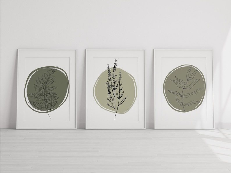 K&ouml;nnte beinhalten: Set aus drei minimalistischen botanischen Drucken mit Strichzeichnungen von Farnen, Lavendel und Eukalyptusbl&auml;ttern in einem Kreis auf gr&uuml;nem Hintergrund.