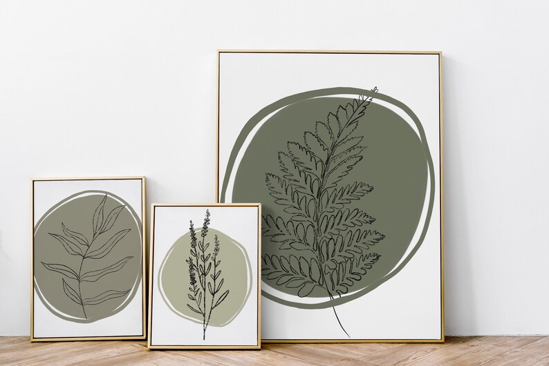 K&ouml;nnte beinhalten: Drei gerahmte Drucke mit minimalistischen Linienzeichnungen von gr&uuml;nem Laub auf wei&szlig;em Hintergrund. Jeder Druck zeigt eine andere Blattart, mit einem gr&uuml;nen Kreis um das Laub.