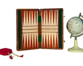 May include: A wooden backgammon game set with a green felt lining, a red velvet bag, and a small globe with a gold stand.